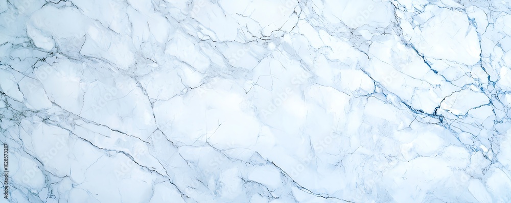 Obraz premium Elegant light blue marble texture with subtle veining, perfect for backgrounds, wallpapers, or design projects.