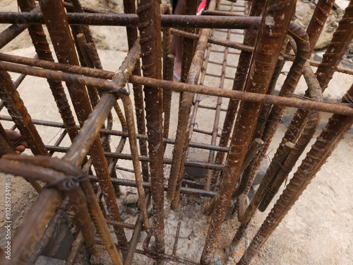 Photography, construction workers using reinforced tmt steel bar with ease at the construction site, Reinforced bar (rebar). TMT steel rods tied together forming the core of concrete