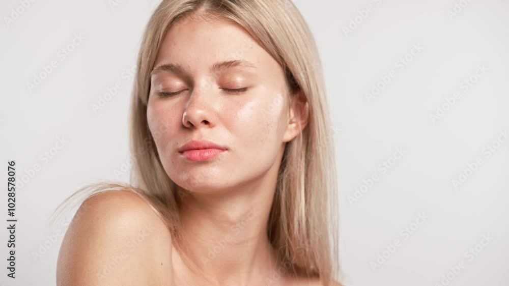 Young blonde woman posing at camera, touching shoulders looking naturally, isolated on white studio background close up shot. Beauty skin care concept Young blonde woman posing at camera, touching shoulders looking naturally, isolated on white studio background close up shot. Beauty skin care concept