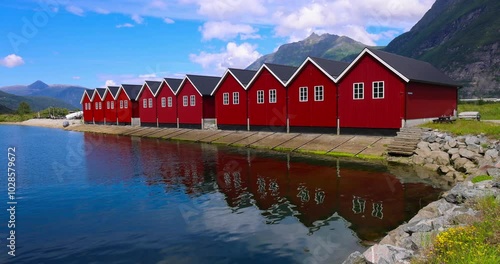 Boathouses in the marina, with calm waters, and mountain in the background at Sunndalsora, Norway photo