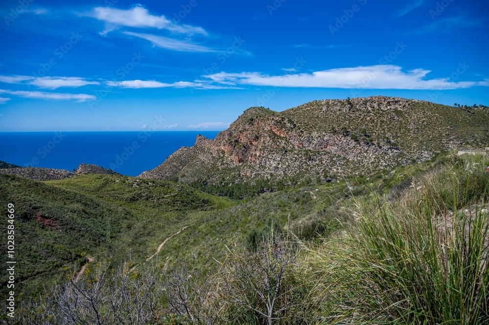 Green mountain range with ocean in the background Green mountain range with ocean in the background