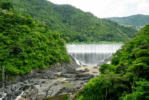 Scenic view of a dam with lush green hills