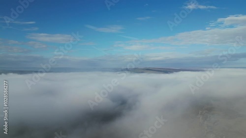 Aerial view of fog and blue sunny sky in the morning at Curbar Edge in Derbyshire, UK photo