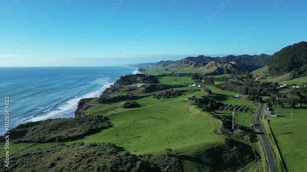 Drone view of green field by the sea with blue sky at the Three Sisters Lookout, on a sunny day Drone view of green field by the sea with blue sky at the Three Sisters Lookout, on a sunny day