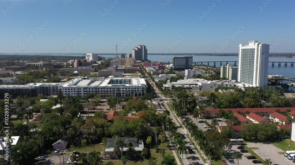 street in Fort Myers, surrounded by buildings and trees, with Caloosahatchee River in the view street in Fort Myers, surrounded by buildings and trees, with Caloosahatchee River in the view