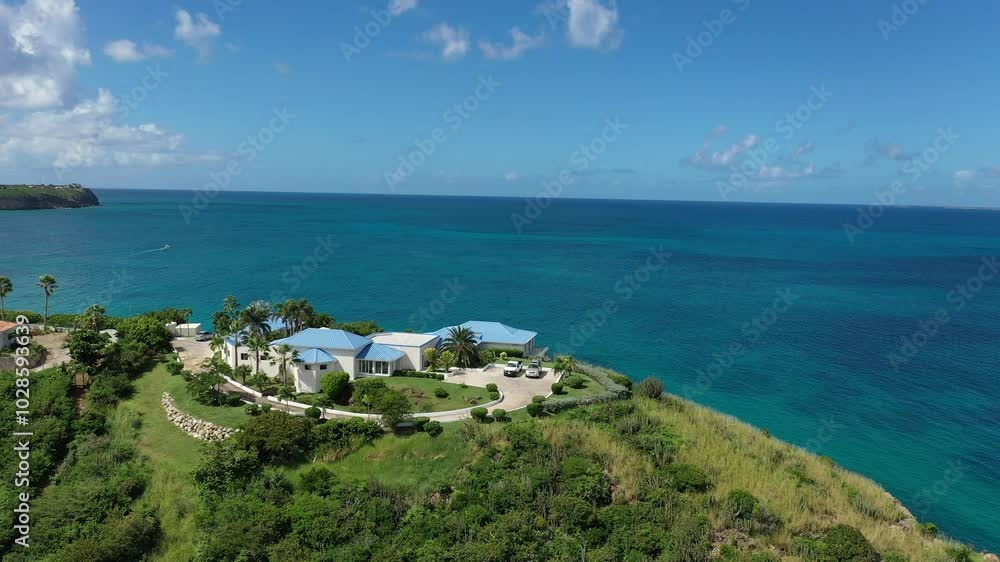 Drone flying over a luxury estate on a hilltop on Saint Martin Island in the Caribbean Sea