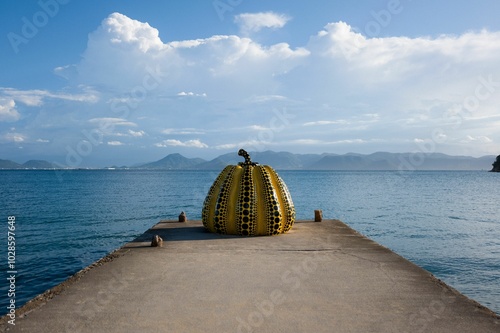 Wallpaper Mural Yellow polka-dotted pumpkin sculpture by the sea Torontodigital.ca