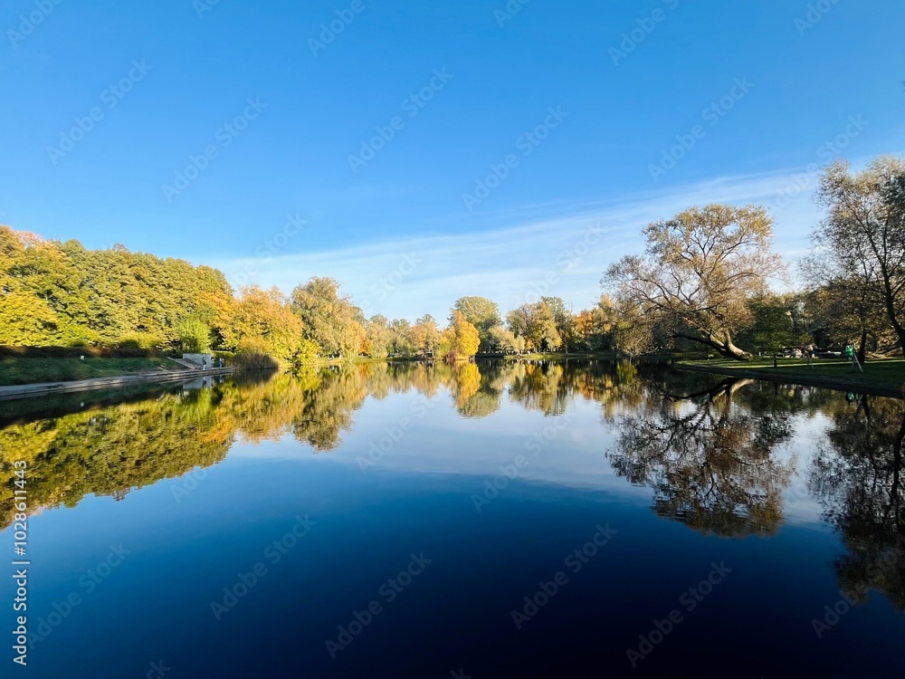 autumn trees reflection on the lake surface, blue lake reflection, golden autumn, lake in the park with quiet water as a mirror autumn trees reflection on the lake surface, blue lake reflection, golden autumn, lake in the park with quiet water as a mirror