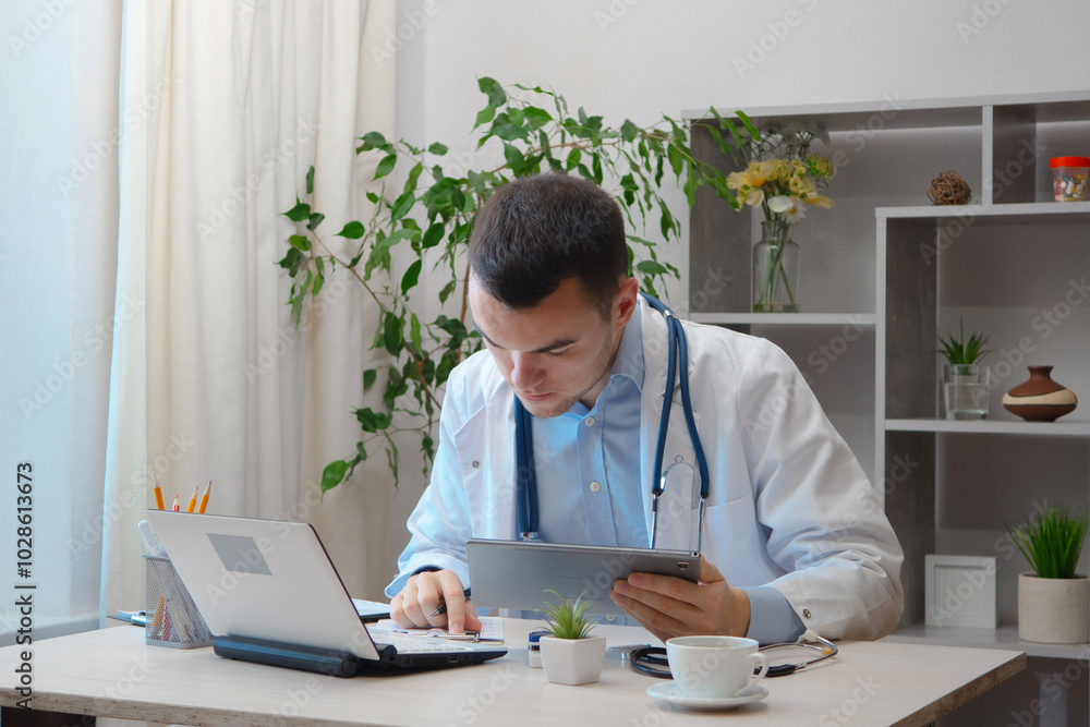 Fototapeta premium A young doctor, at his desk, receives patients.