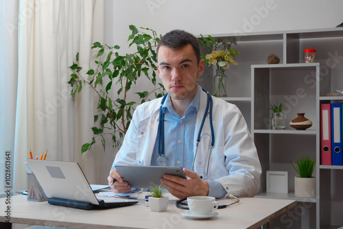 A young doctor, at his desk, receives patients.