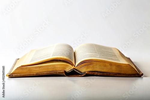 Open bible on white background with aged pages as seen from below