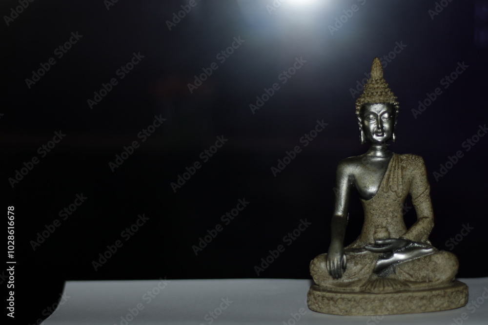 Serene Buddha Statue on empty colorful backdrop with copy space, yoga, meditation and relaxation time. Symbolizing peace and enlightenment. Serene Buddha Statue on empty colorful backdrop with copy space, yoga, meditation and relaxation time. Symbolizing peace and enlightenment.