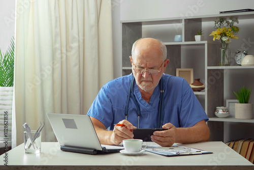 An elderly man, a doctor, in his office, at a table.