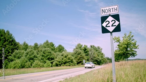 Vehicles driving on North M-22 in Empire, Michigan with stable video in slow motion. photo