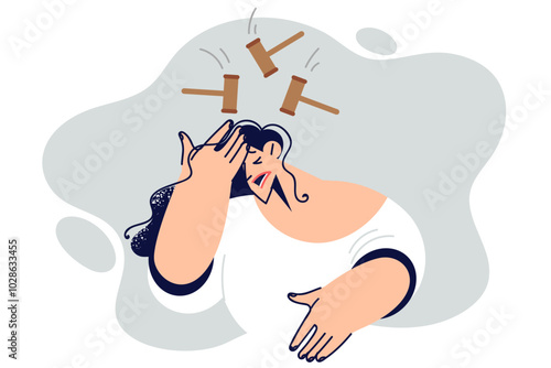 Woman suffers from headache and migraine, feeling hammer blows on head due to hangover