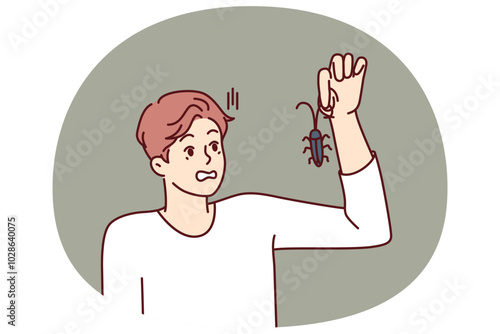 Man with bug in hand, looks at insect and gets scared suffering from arachnophobia and disgust. Guy found bug and wants to get rid of pest by calling service for chemical treatment of insects