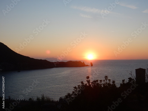 Sunset in Giglio Campese with Montecristo island in the background, Tuscan archipelago, Tyrrhenian sea, Italy photo