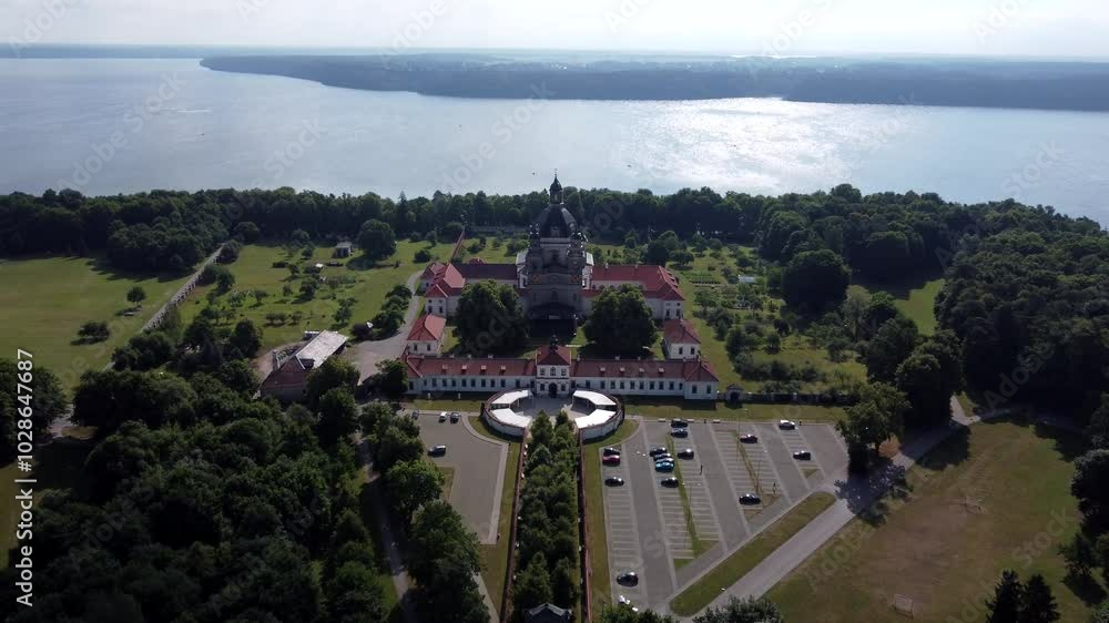 Pazaislis Monastery and Church surrounded by green spaces on a sunny morning in Lithuania