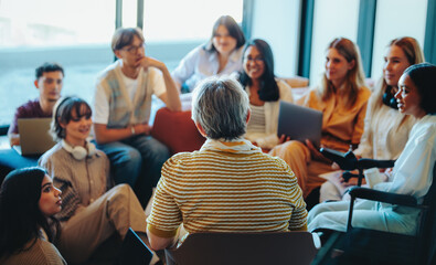 Multigenerational group gathered for a learning session with diverse students listening to an experienced speaker