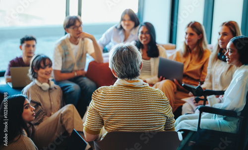 Multigenerational group gathered for a learning session with diverse students listening to an experienced speaker photo