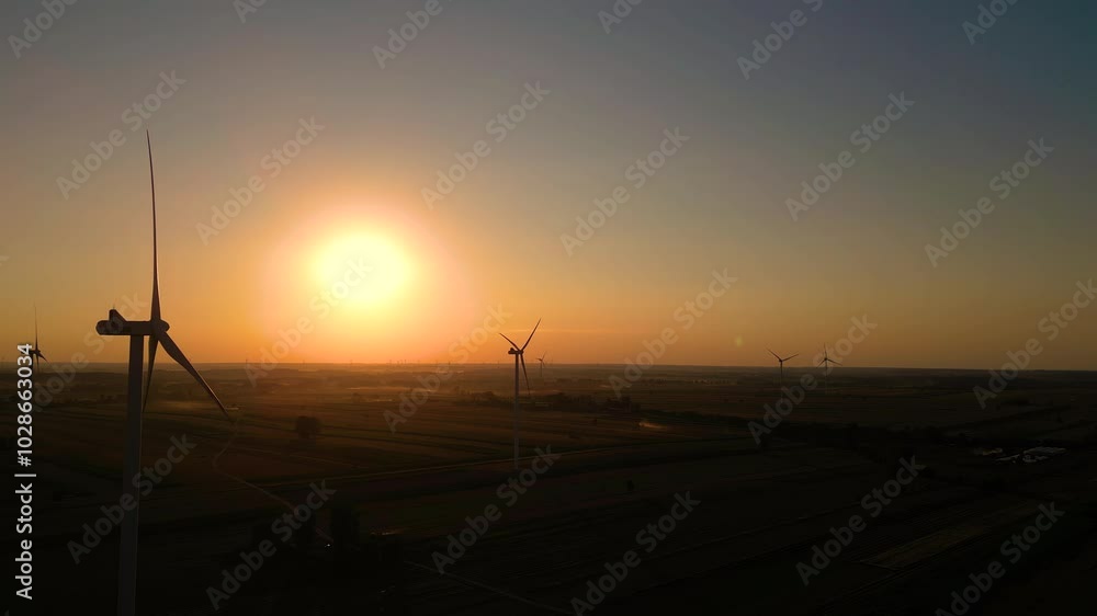 Sunset over a wind farm in the countryside, showcasing renewable energy and nature's beauty during golden hour Sunset over a wind farm in the countryside, showcasing renewable energy and nature's beauty during golden hour