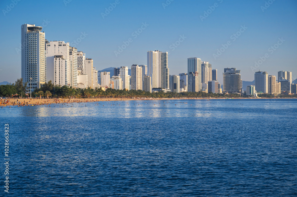Panoramic view of the resort town of Nha Trang in Vietnam with a sandy beach by the sea and skyscrapers of hotels in summer Panoramic view of the resort town of Nha Trang in Vietnam with a sandy beach by the sea and skyscrapers of hotels in summer