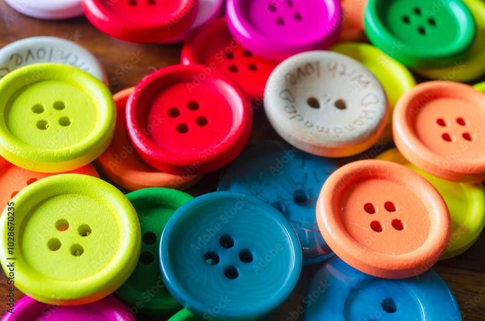 Close-up of coloured buttons on a wooden background Close-up of coloured buttons on a wooden background