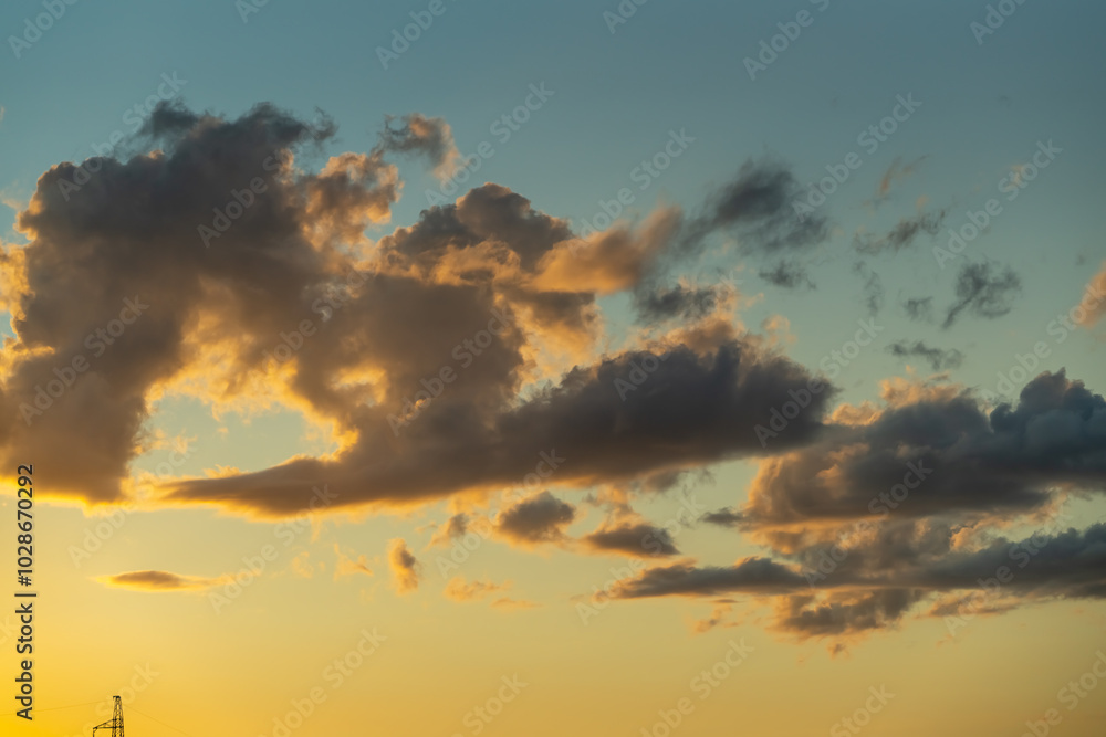 Fototapeta premium Sky background with clot illuminated by the sunset sunlight 