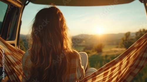 A serene view from the back of a camper van, gazing out at a golden sunset over an open field, embracing freedom and tranquility in a warm embrace.