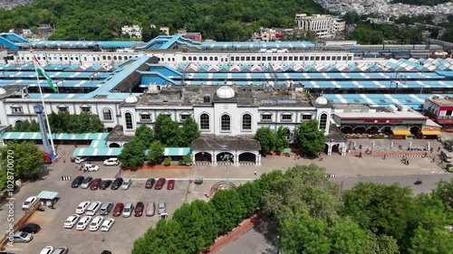 Wide-angle drone footage of a railway station with highway cutting through Amaravathi’s peaceful rural landscapes. photo