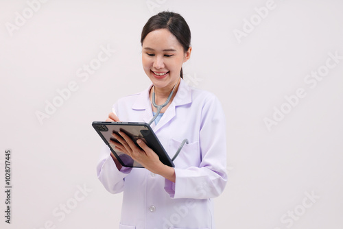 Smiling female doctor holding tablet on white background.