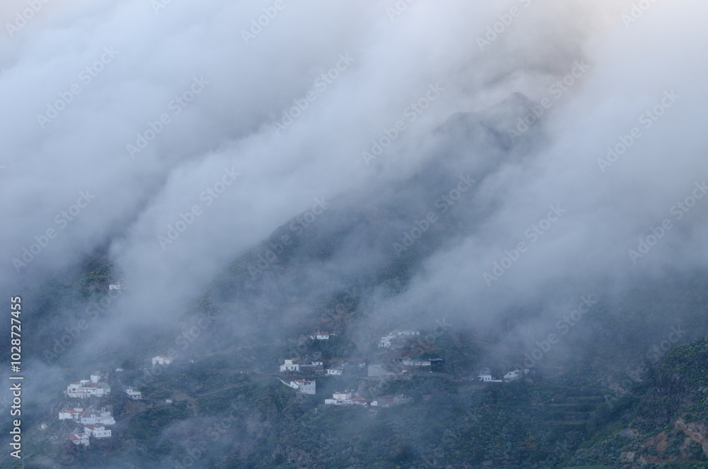 Obraz premium Sea of clouds falling over the caldera de Tejeda and village of Cuevas Caidas in the foreground. Tejeda. Gran Canaria. Canary Islands. Spain.