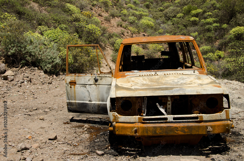 Abandoned and burned car. The Nublo Rural Park. Gran Canaria. Canary Islands. Spain. Abandoned and burned car. The Nublo Rural Park. Gran Canaria. Canary Islands. Spain.