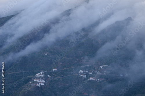 Sea of clouds falling over the caldera de Tejeda and village of Cuevas Caidas in the foreground. Tejeda. Gran Canaria. Canary Islands. Spain.