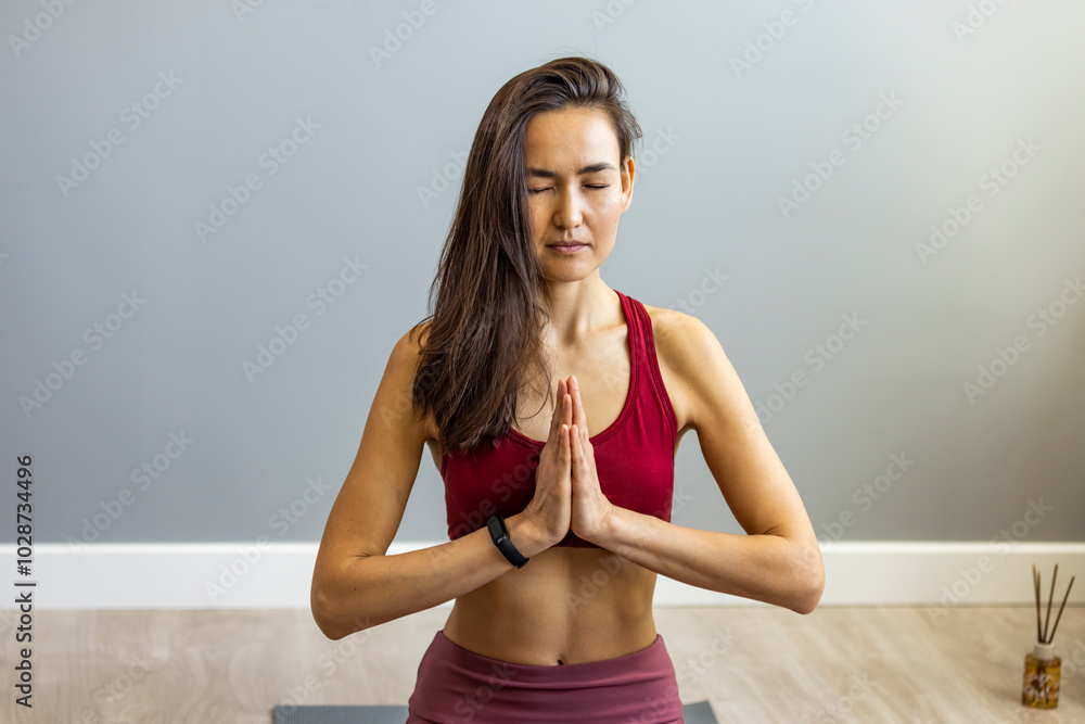 Fototapeta premium Focused Woman Practicing Yoga Meditation in Serene Indoor Space