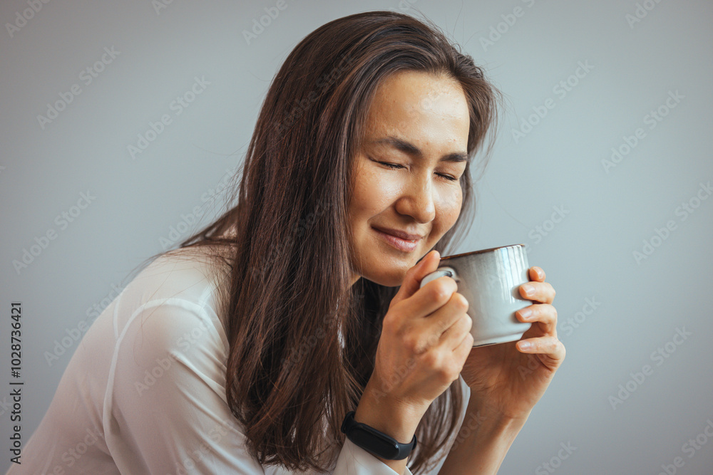 Smiling Woman Enjoying a Hot Beverage at Home Smiling Woman Enjoying a Hot Beverage at Home