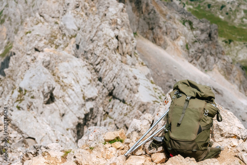 Obraz na płótnie Hiking Backpack and Trekking Poles on Rock in Mountains w salonie