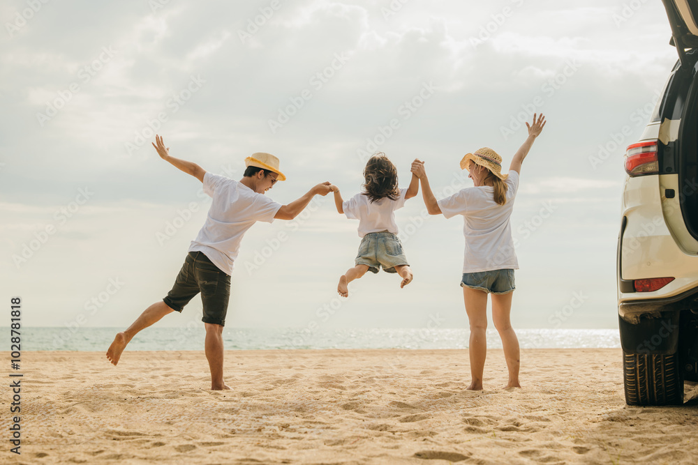 Happy family three hand in hand and jumping on sandy beach, Parents father and mother jump their children back car, holiday vacations summer road trip, Family day enjoying their time together Happy family three hand in hand and jumping on sandy beach, Parents father and mother jump their children back car, holiday vacations summer road trip, Family day enjoying their time together