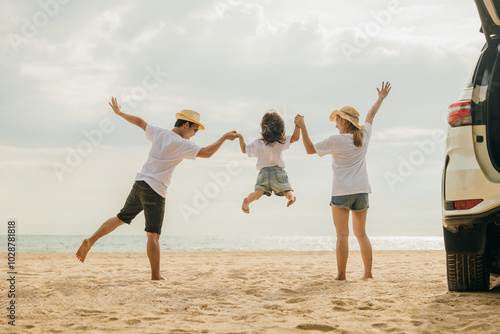 Happy family three hand in hand and jumping on sandy beach, Parents father and mother jump their children back car, holiday vacations summer road trip, Family day enjoying their time together