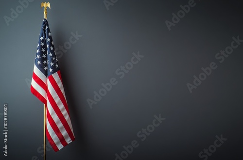 American flag displayed against a dark background in an indoor setting during...