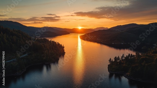 Sunset Over a Serene Lake Surrounded by Lush Evergreen Forests