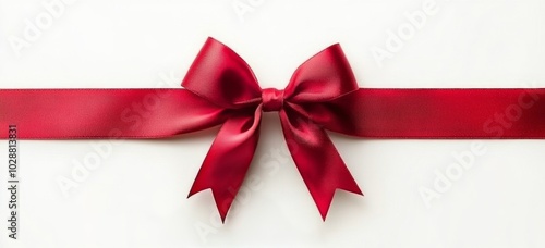A beautifully crafted red ribbon and bow on a white background creating an el...