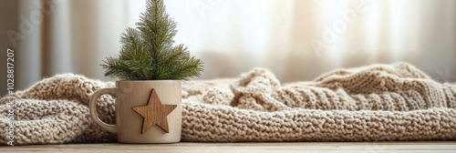 A cozy winter setting with a decorated mug and small evergreen plants on a so...