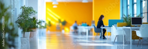 Bright modern office space with creative workstations and plants during dayti...