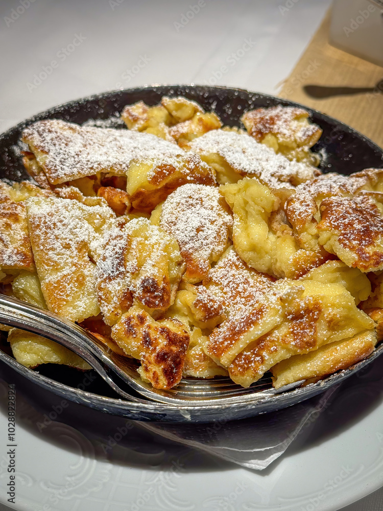 Famous Austrian sweet dish Kaiserschmarrn served in a pan Famous Austrian sweet dish Kaiserschmarrn served in a pan
