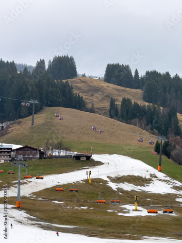 Obraz na płótnie Very bad and poor snow conditions in alpine ski region of Saalbach-Hinterglemm at the end of the season in March 2024 against cloudy sky w salonie