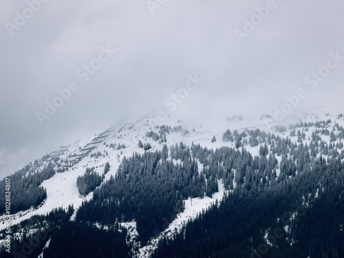 Scenic view of snow covered mountain and snow line in the ski region of Saalbach-Hinterglemm in the Austrian alps against cloudy sky