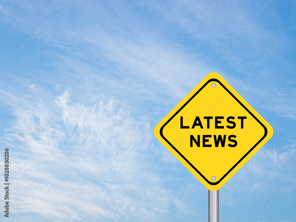 Yellow transportation sign with word latest news on blue color sky background Yellow transportation sign with word latest news on blue color sky background