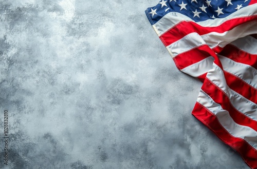 Tattered American flag displaying faded stars and worn fabric against a dark ...