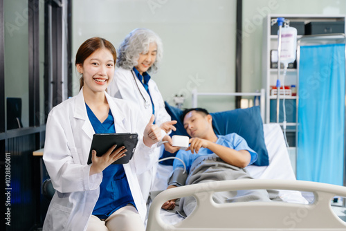 Hospital Ward Male and Male Professional Asian Doctors Talk with a Patient, Give Health Care Advice,